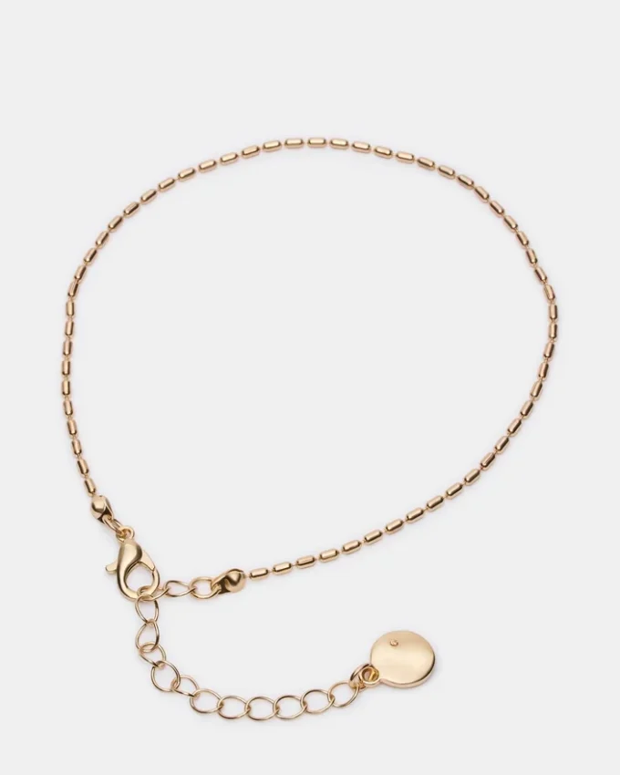 Conjunto de tobilleras con cadena en espiga dorada
