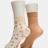Paquete de 2 pares de calcetines tobilleros transparentes con diseño floral, color vainilla Paquete de 2 pares de calcetines tobilleros transparentes con diseño floral, color vainilla