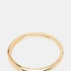 Pulsera tipo brazalete delgada dorada